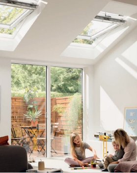 A mum and her children play in a sunny conservatory under skylights supported by an Iceni Roofing roof.
